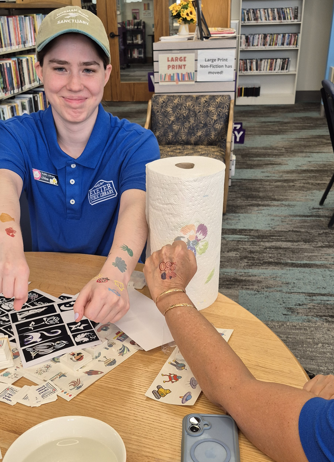 Librarians showing off their temporary tattoos during the Kickoff Party.